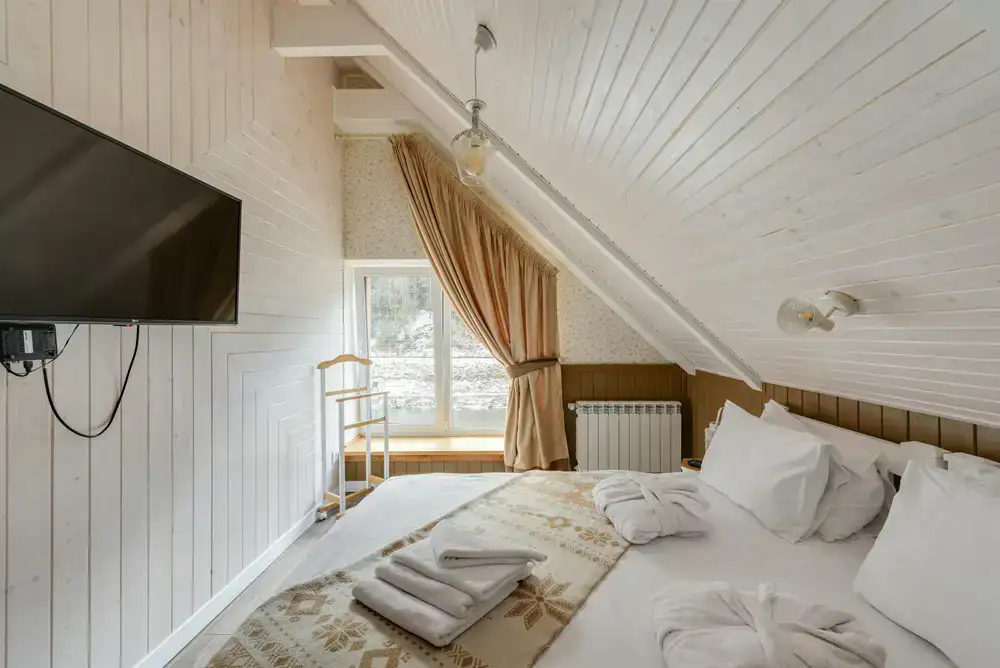 Comfortable bed with warm blankets in a lodge guest room