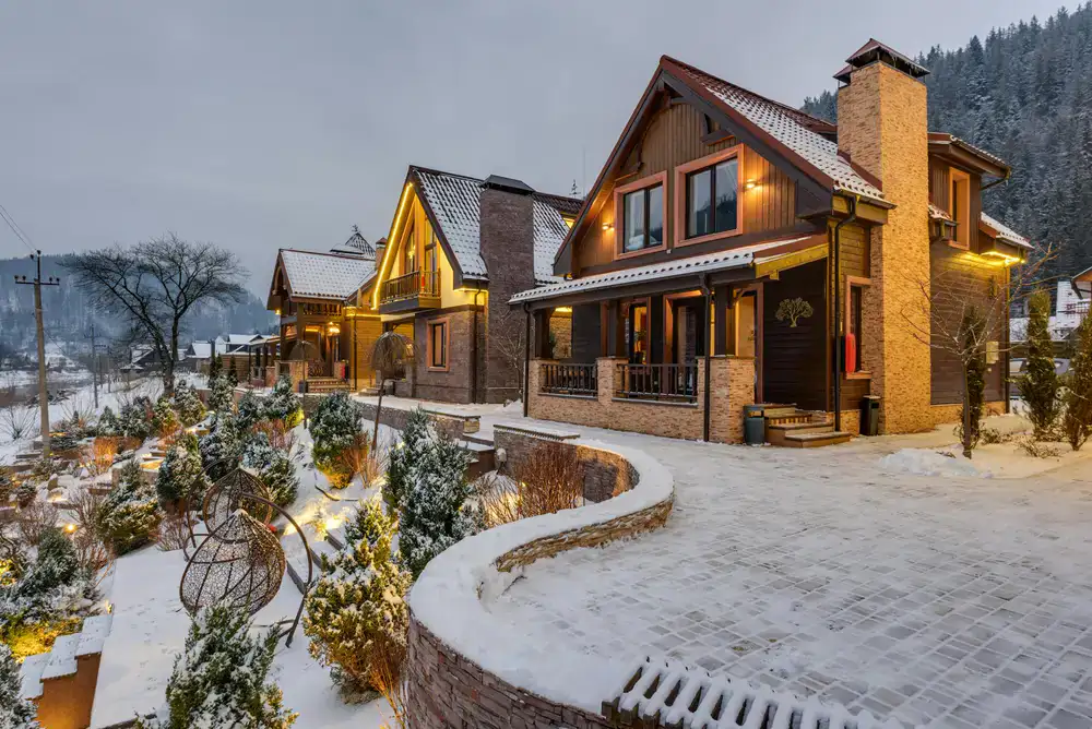 An old photograph style view or rustic view of the lodge nestled in snow