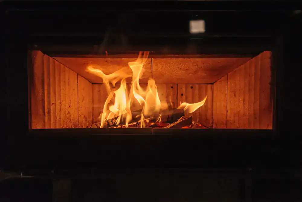 A warm and inviting living area inside the winter lodge with a glowing fireplace